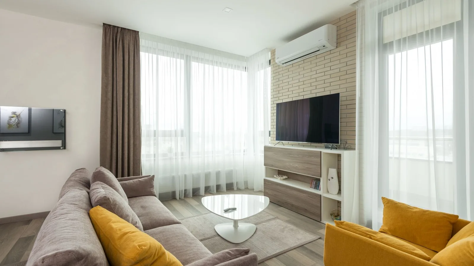 Wall-mounted 24,000 BTU mini split best 2026 indoor unit above a television in a modern living room