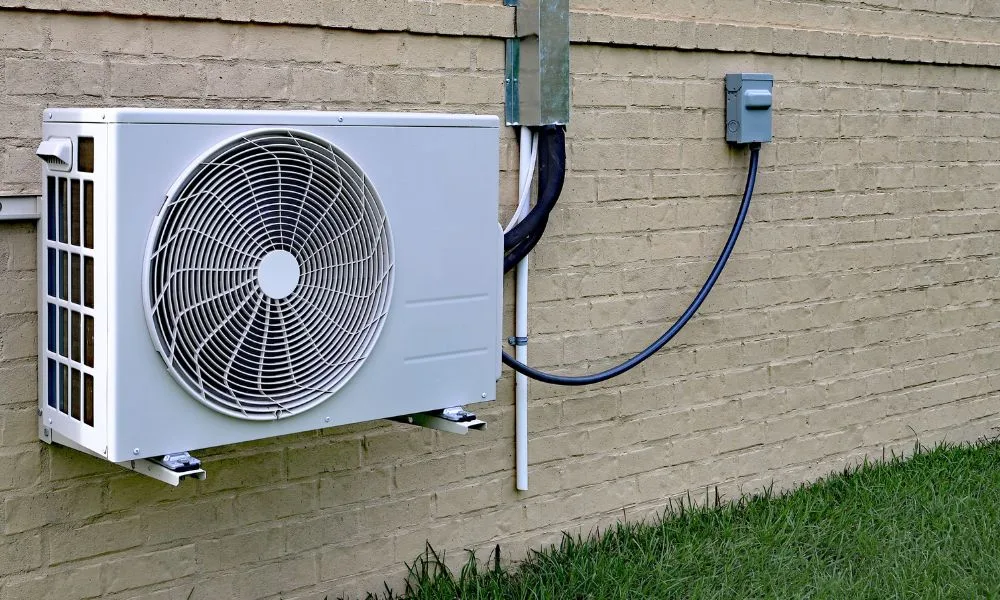 Easiest DIY mini split install — wall-mounted outdoor condenser with pre-charged line set and electrical disconnect on a brick exterior wall